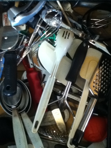 Cluttered kitchen utensil drawer